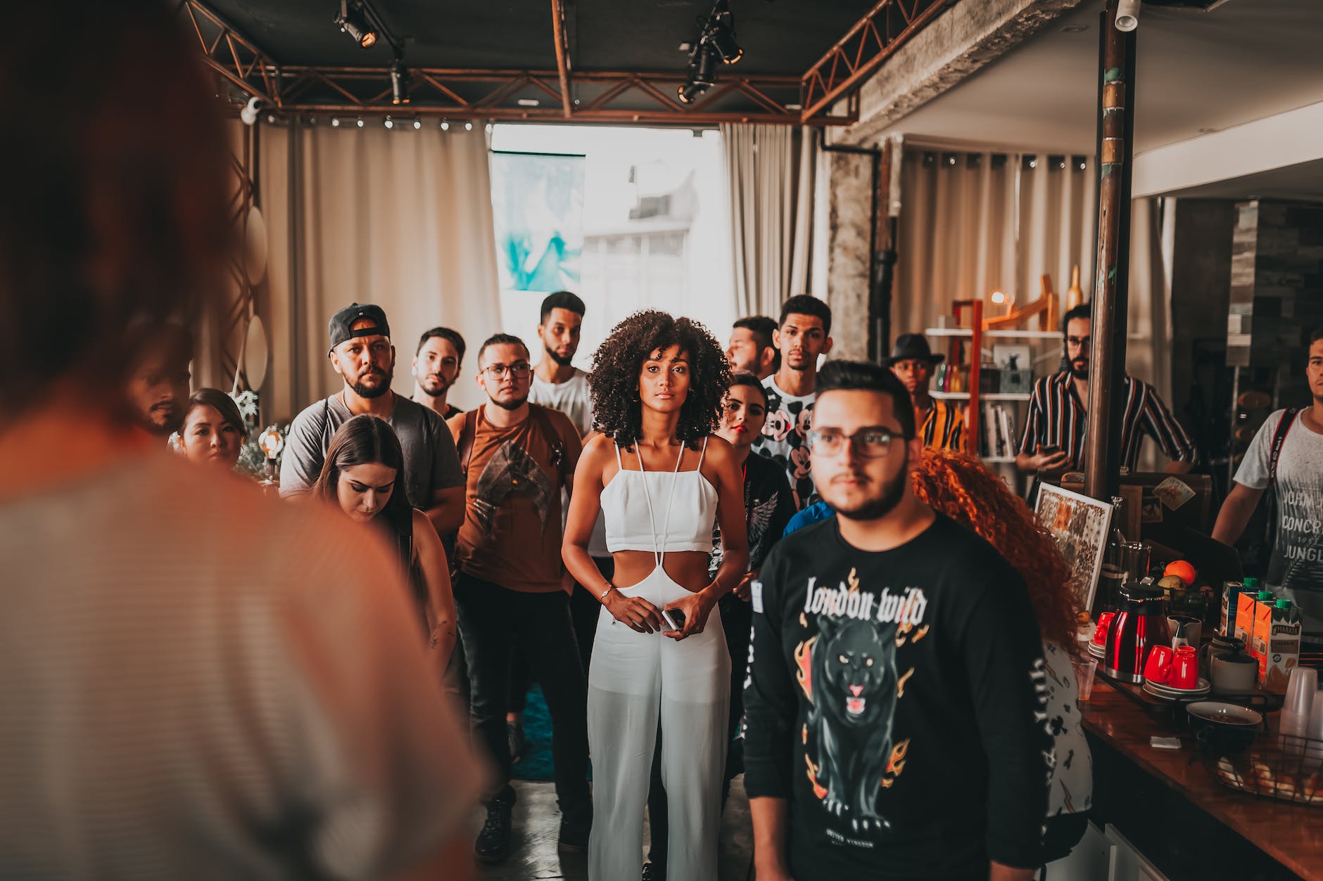 diverse people listening to speaker in modern studio