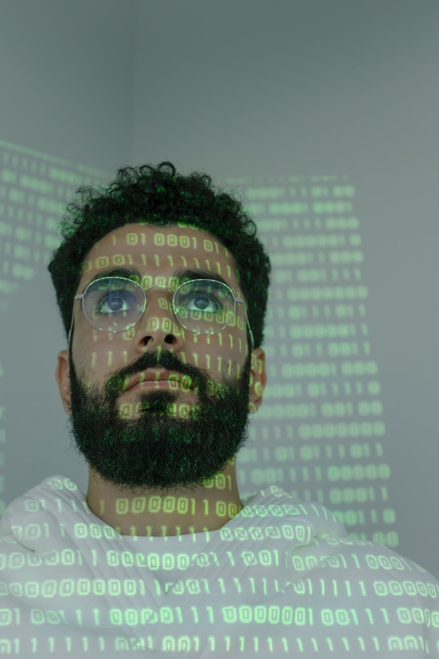 man with binary code projected on his face